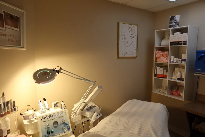 Facial treatment bed and equipment in a treatment room at Serenity Med Spa